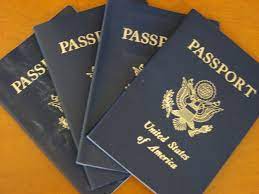 Picture of 4 passport books on a table.